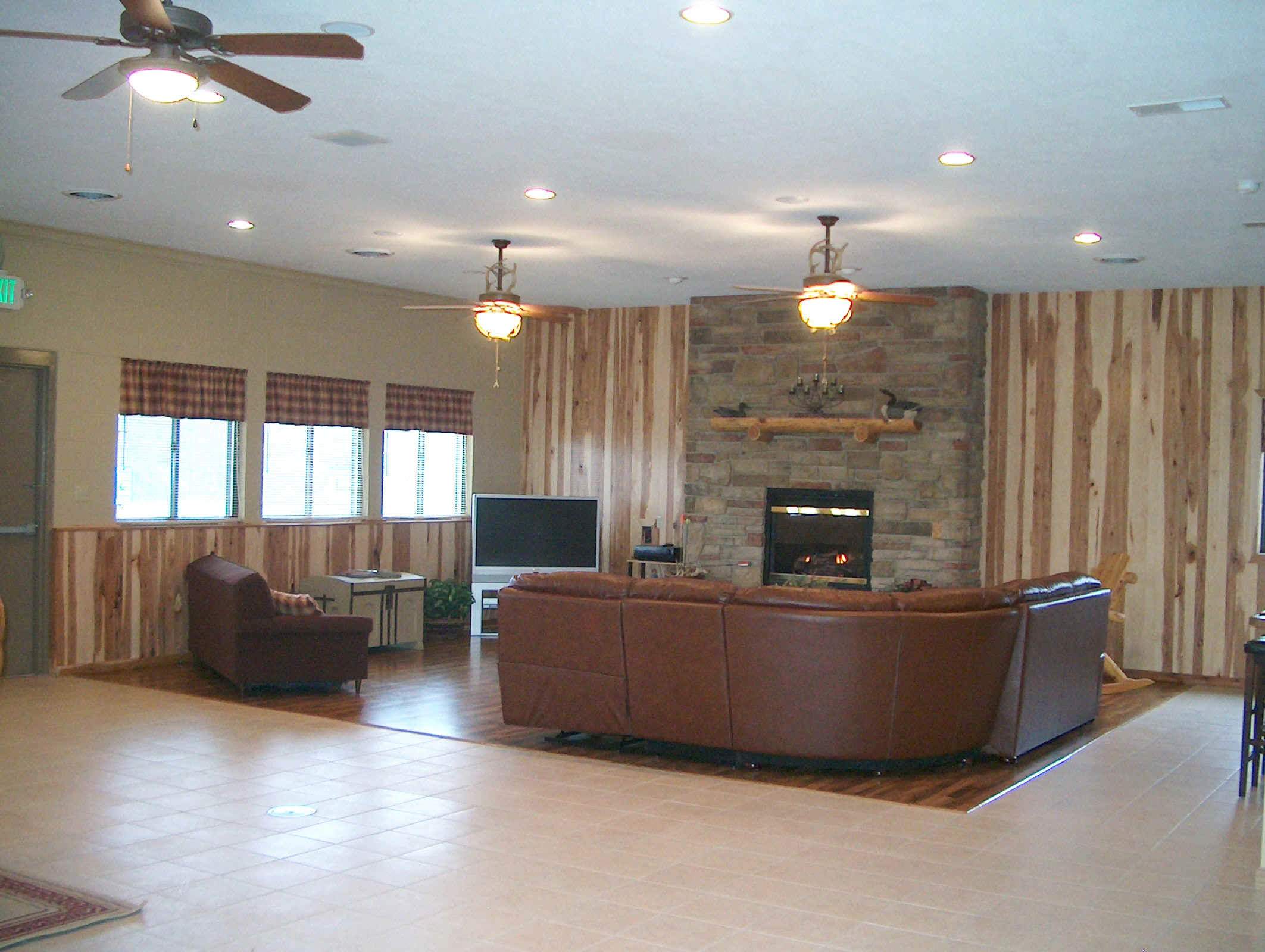 Lounge area with fireplace and widescreen TV -  Langham Outdoors Lodge building